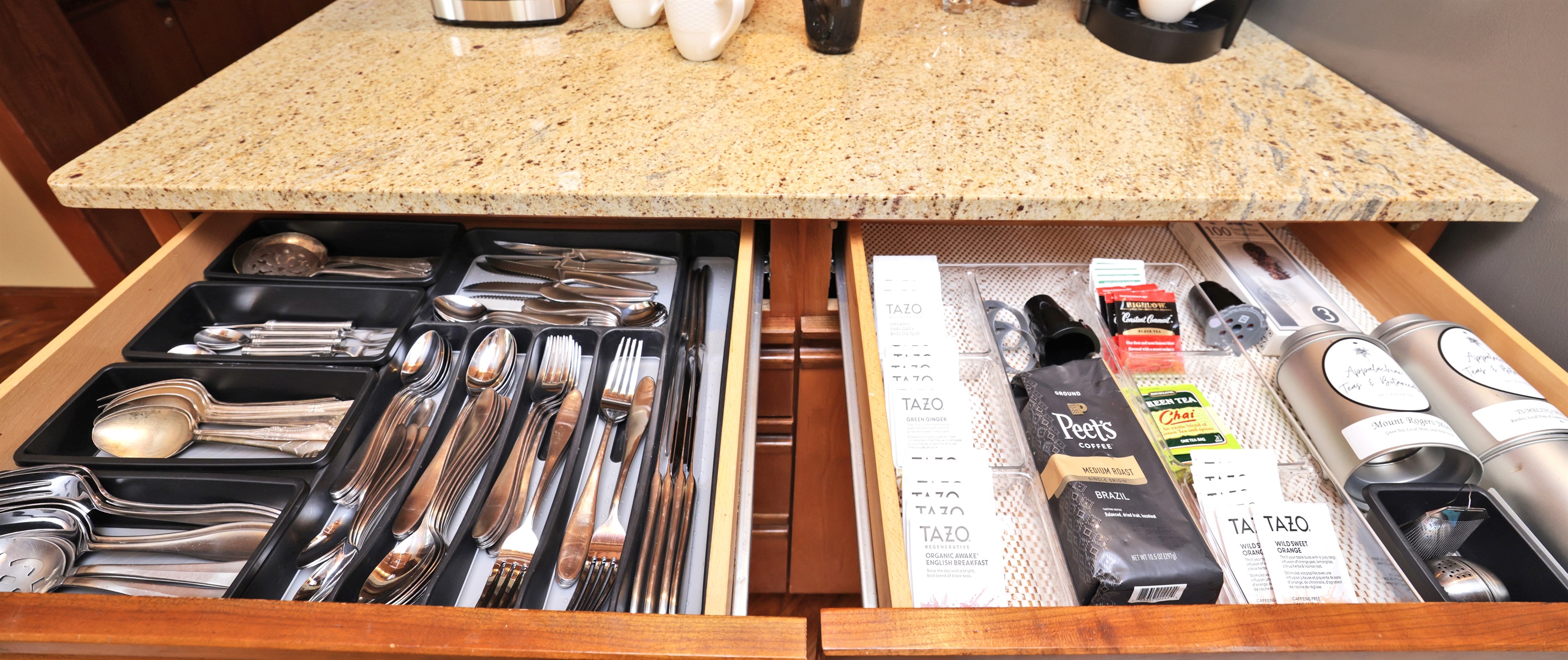 Flatware and serving ware plus coffee/tea drawer at right.