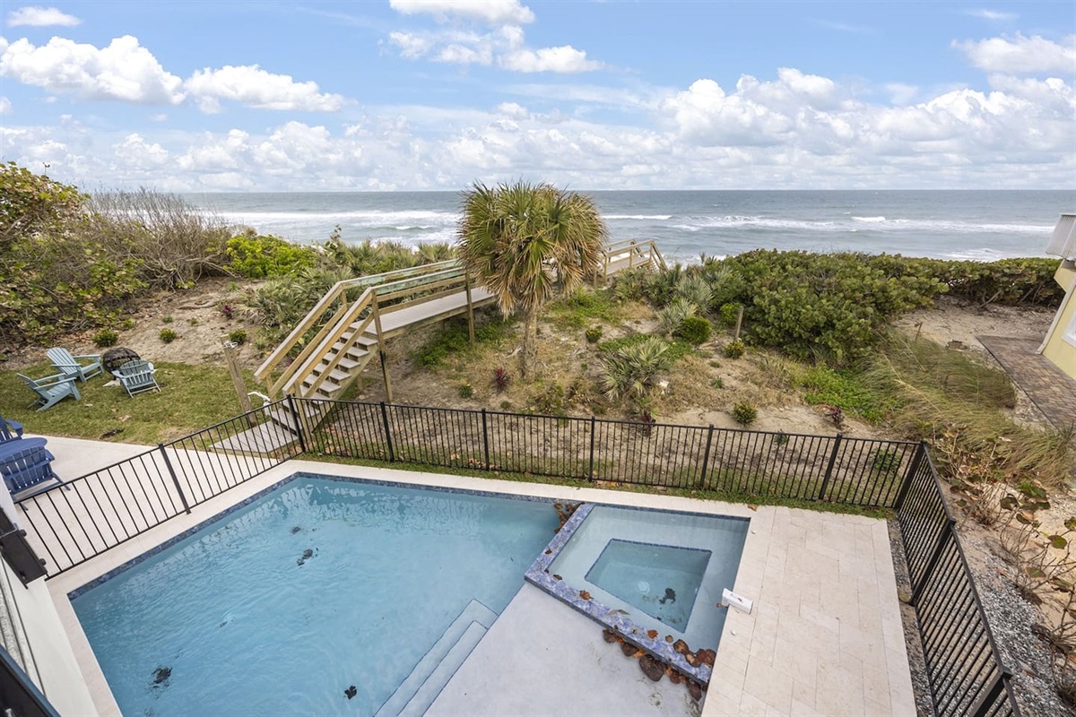 Step outside to the stunning exterior of the house, featuring a sparkling swimming pool with a breathtaking view of the ocean, offering the perfect spot to relax and take in the natural beauty of the surroundings.