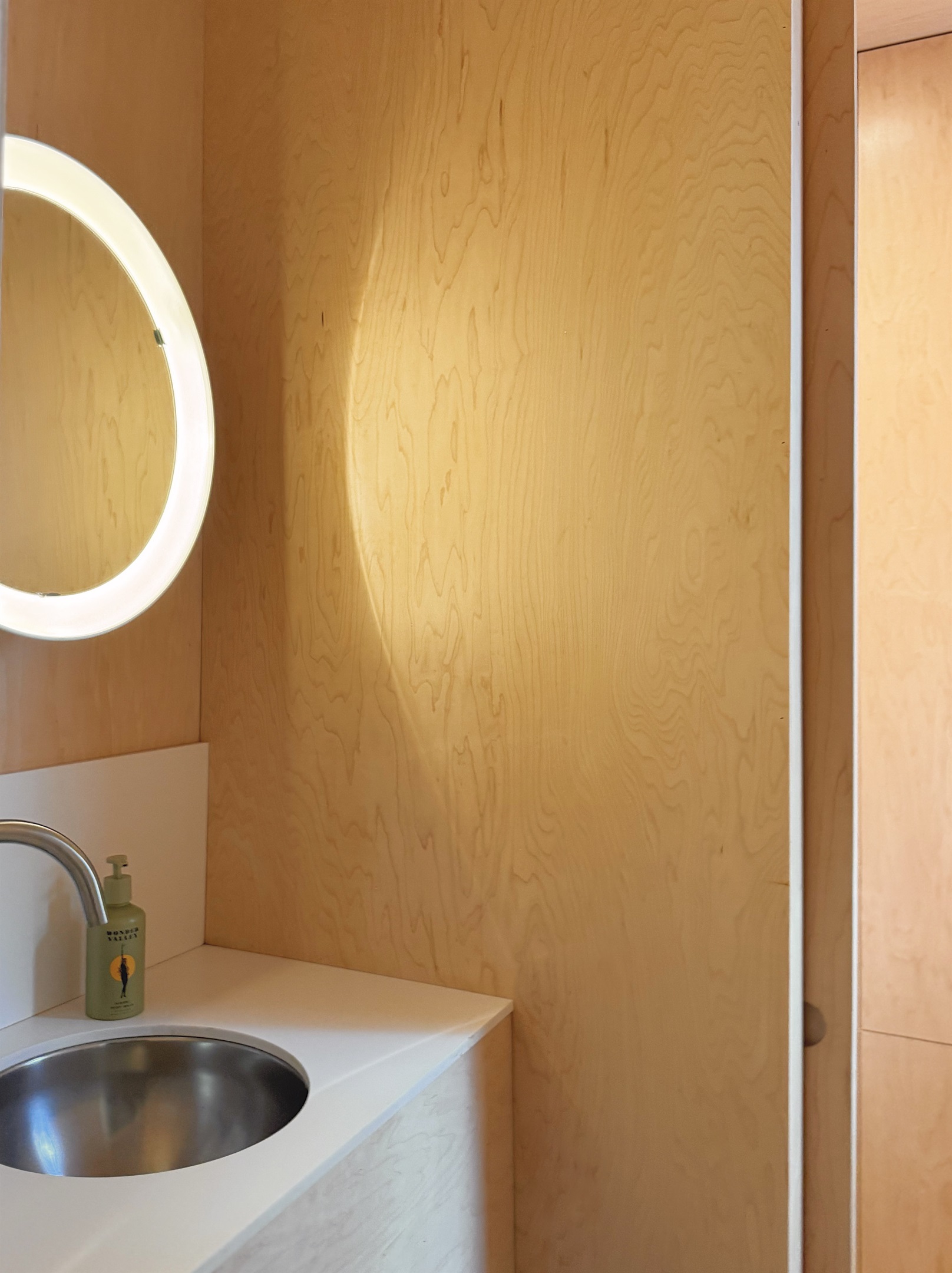 Half bath with vintage danish lighting.