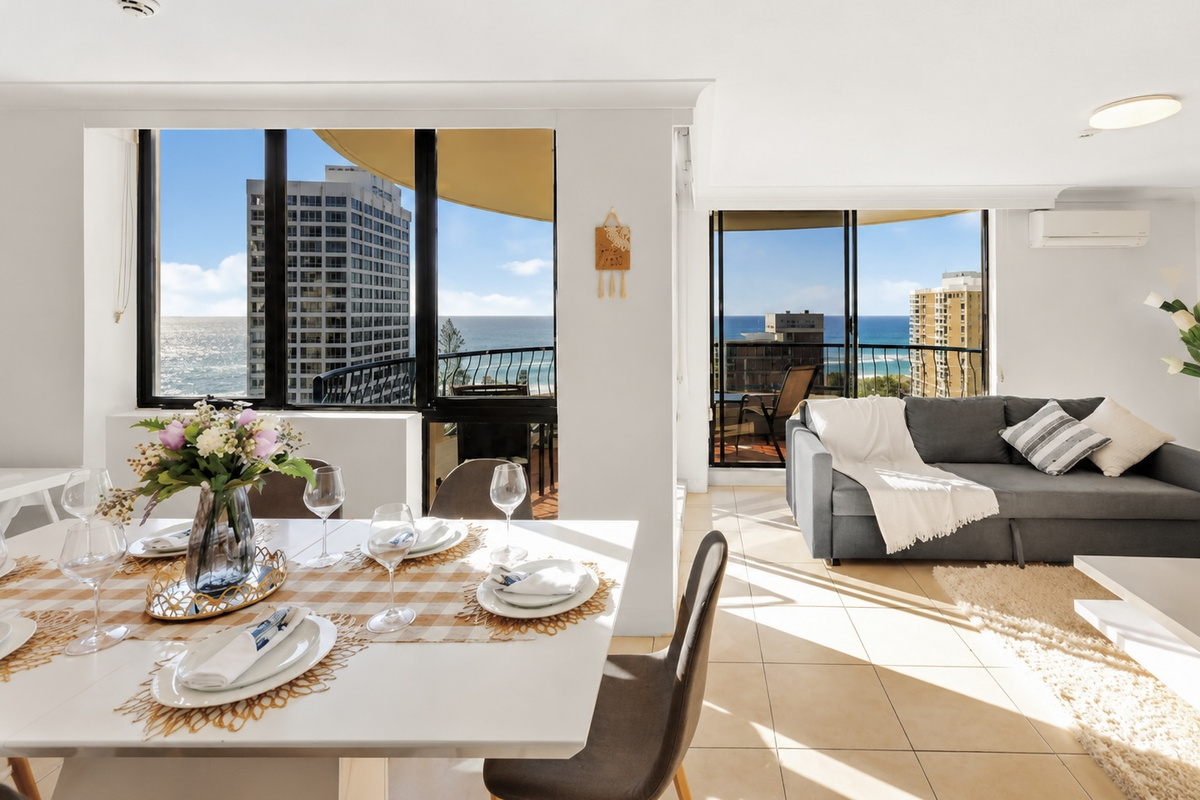 Natural light and high-rise outlooks make the dining area feel open, with the kitchen and lounge close for easy apartment living.