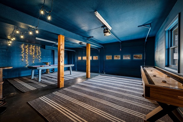 Spacious game room with pool, ping pong, shuffleboard, and high-top seating—built for fun, games, and group hangouts.