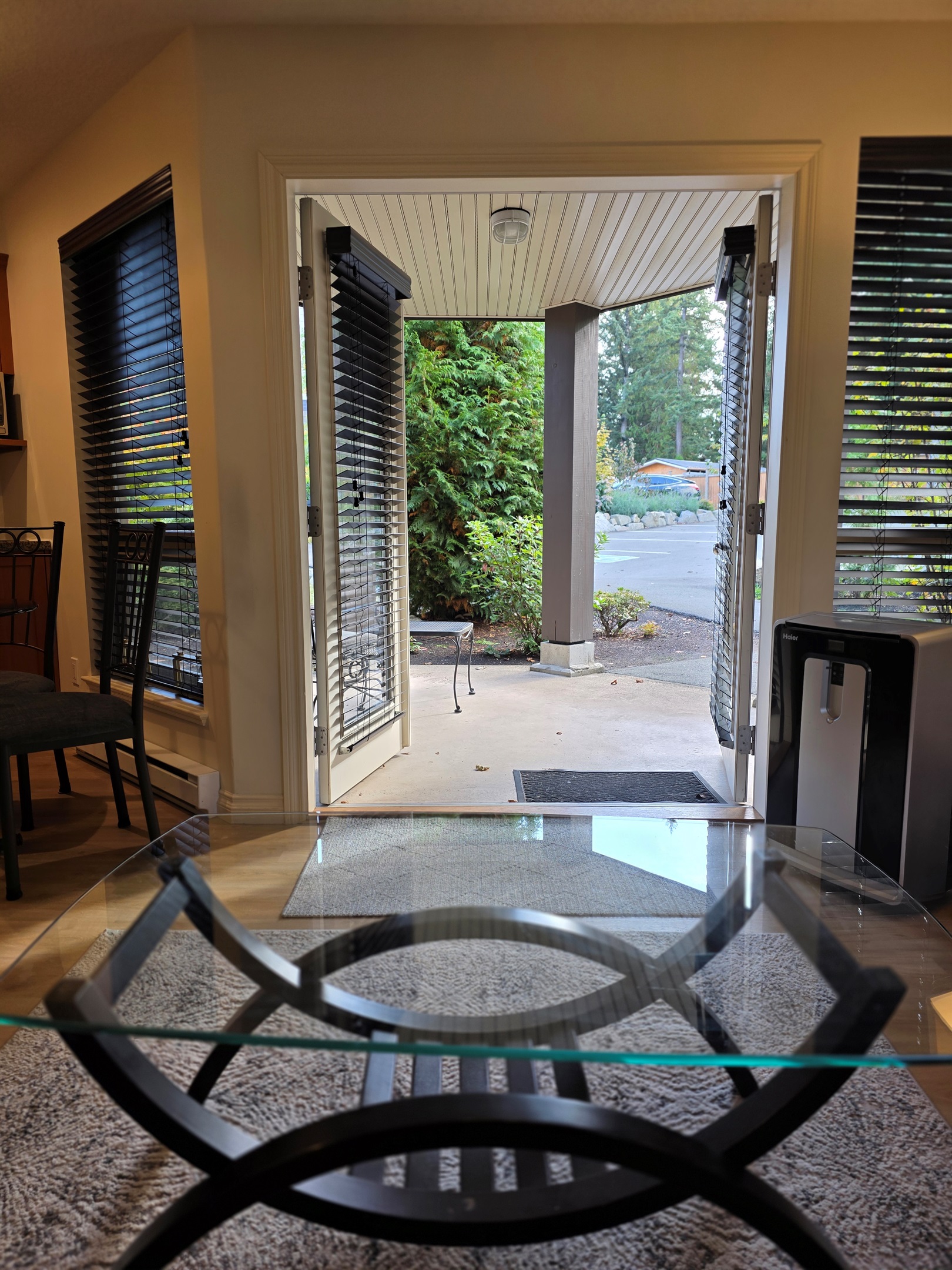 Unit  B Double glass doors opening to Covered patio with outdoor seating in  