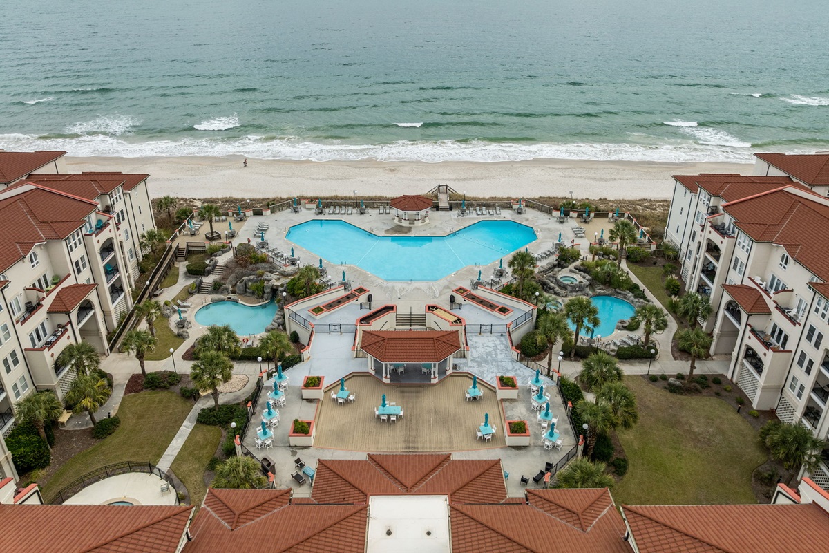 Resort-style amenities at Villa Capriani, featuring multiple seasonal pools & hot tubs, waterfalls, and direct beach access