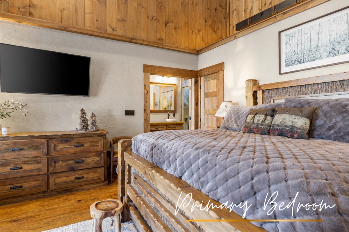 Bedroom1: Unwind in the comforts of the master suite, featuring a luxurious king-sized bed, rustic charm, and warm wood accents for a cozy, inviting retreat.