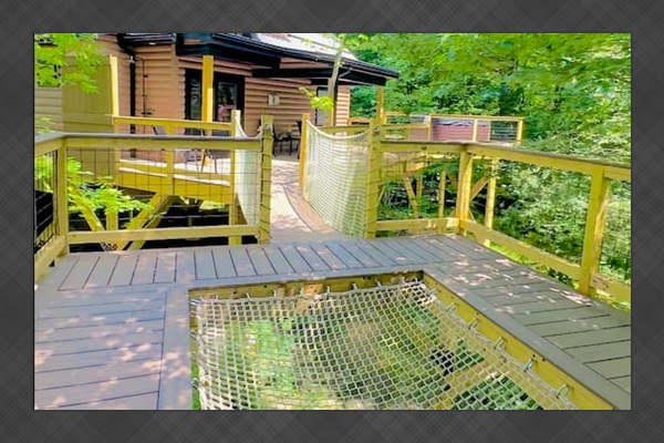 This unique treehouse deck offers a luxurious outdoor experience with an elevated hot tub and XL hammock seamlessly built into the deck floor. Additionally, enjoy the refreshing outdoor shower while surrounded by nature, making it a perfect retreat.