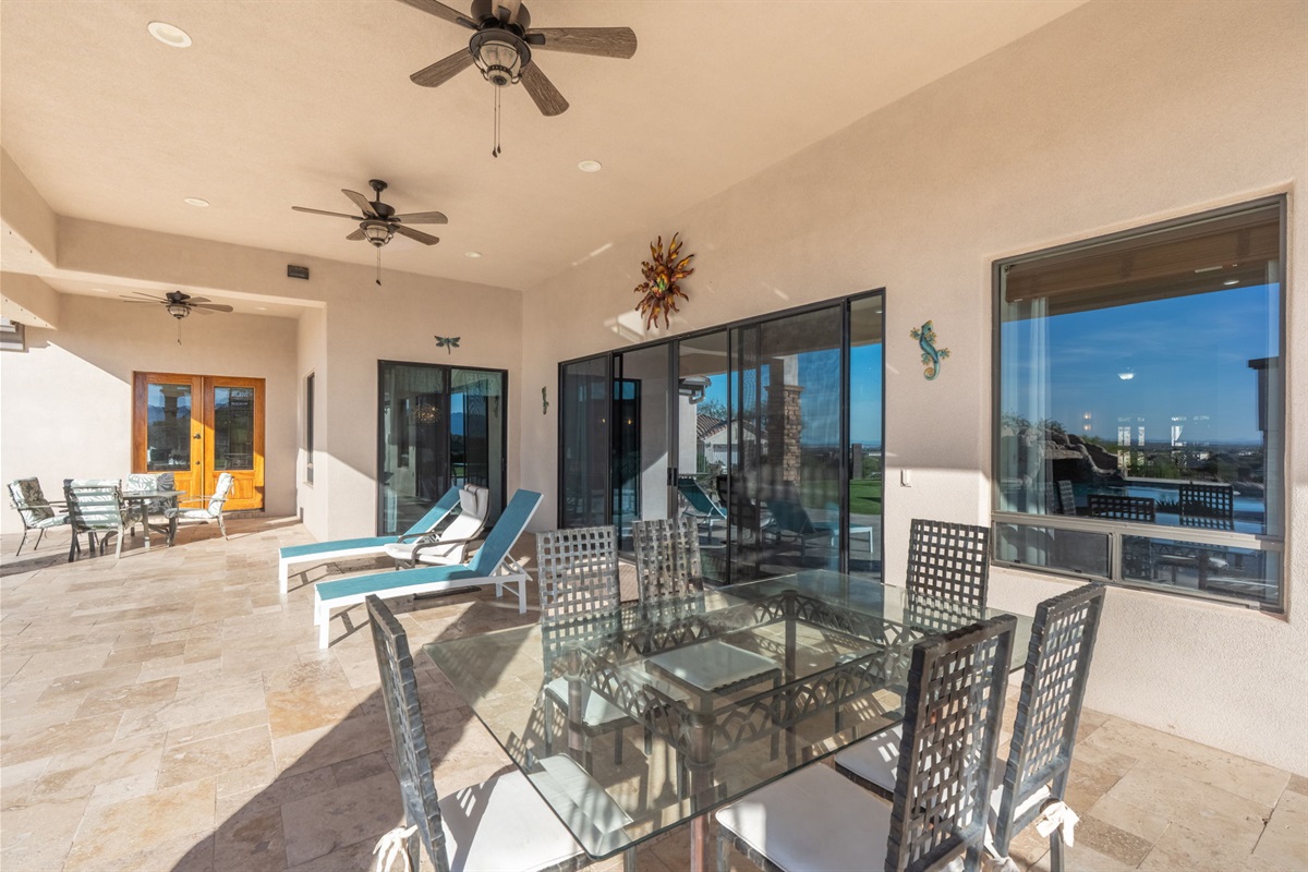Indoor-outdoor living connection with shaded seating and backyard views makes relaxing effortless all day long