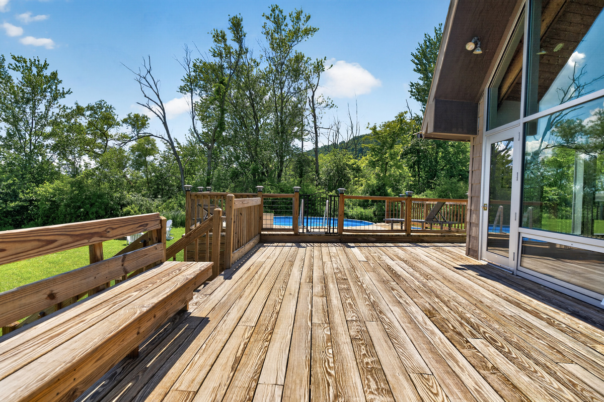 Wooden deck extending alongside the home