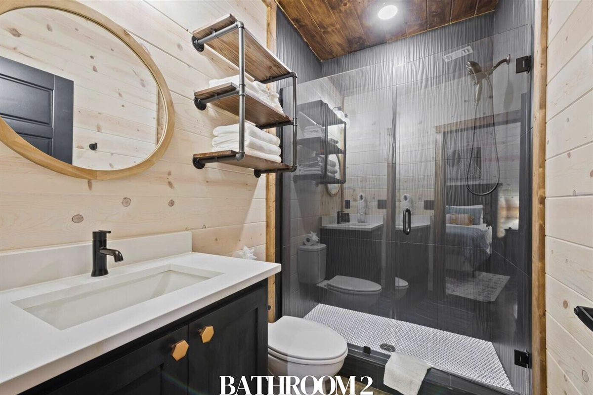 Bathroom 2: En-suite with walk-in shower, vanity, and rustic-modern style.