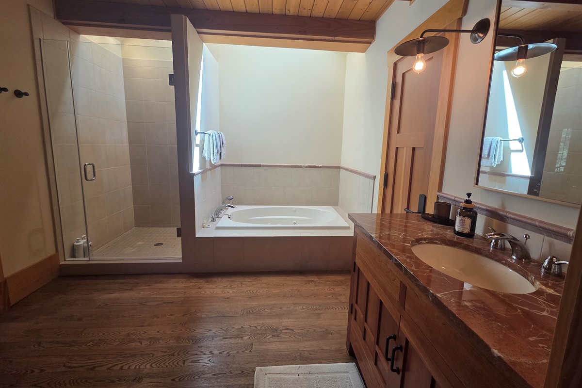 The carriage house includes its own private bathroom, separate from the main house, with a soaking tub and a large walk-in shower for added comfort.