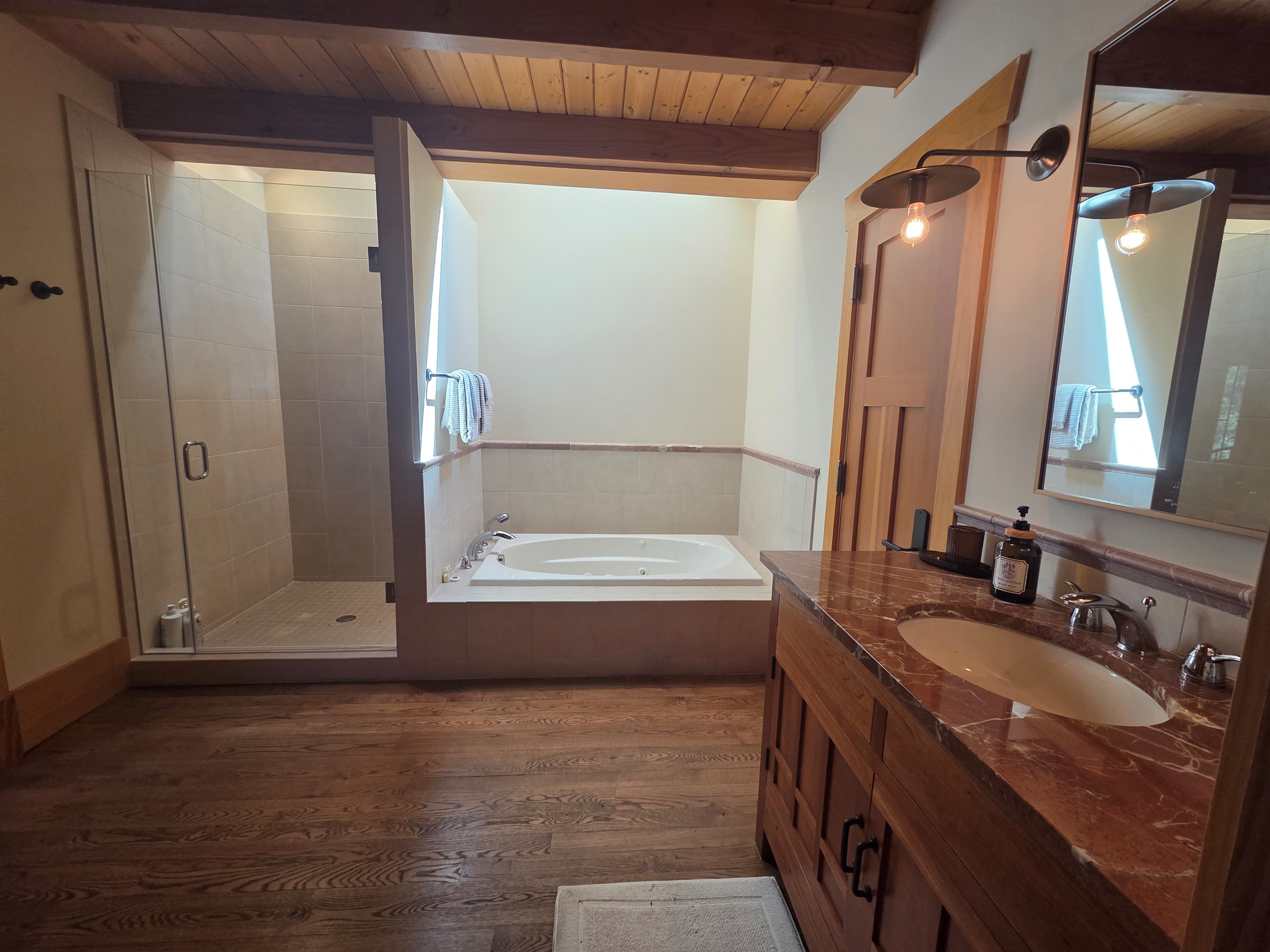The carriage house includes its own private bathroom, separate from the main house, with a soaking tub and a large walk-in shower for added comfort.