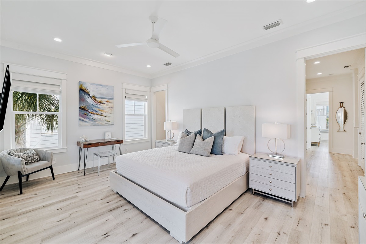Second-floor master ensuite featuring a king bed, smart TV, writing desk, large walk-in closet, and private screened-in balcony.