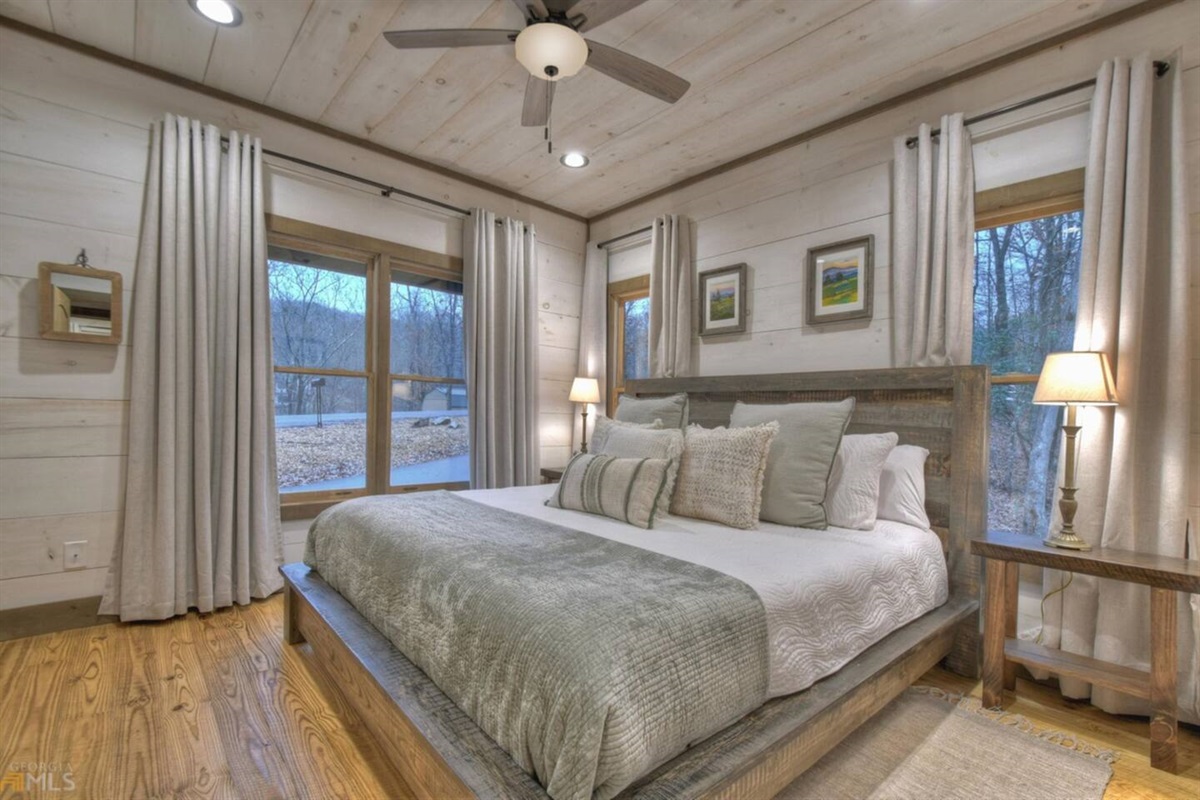 Main floor bedroom with king bed and TV