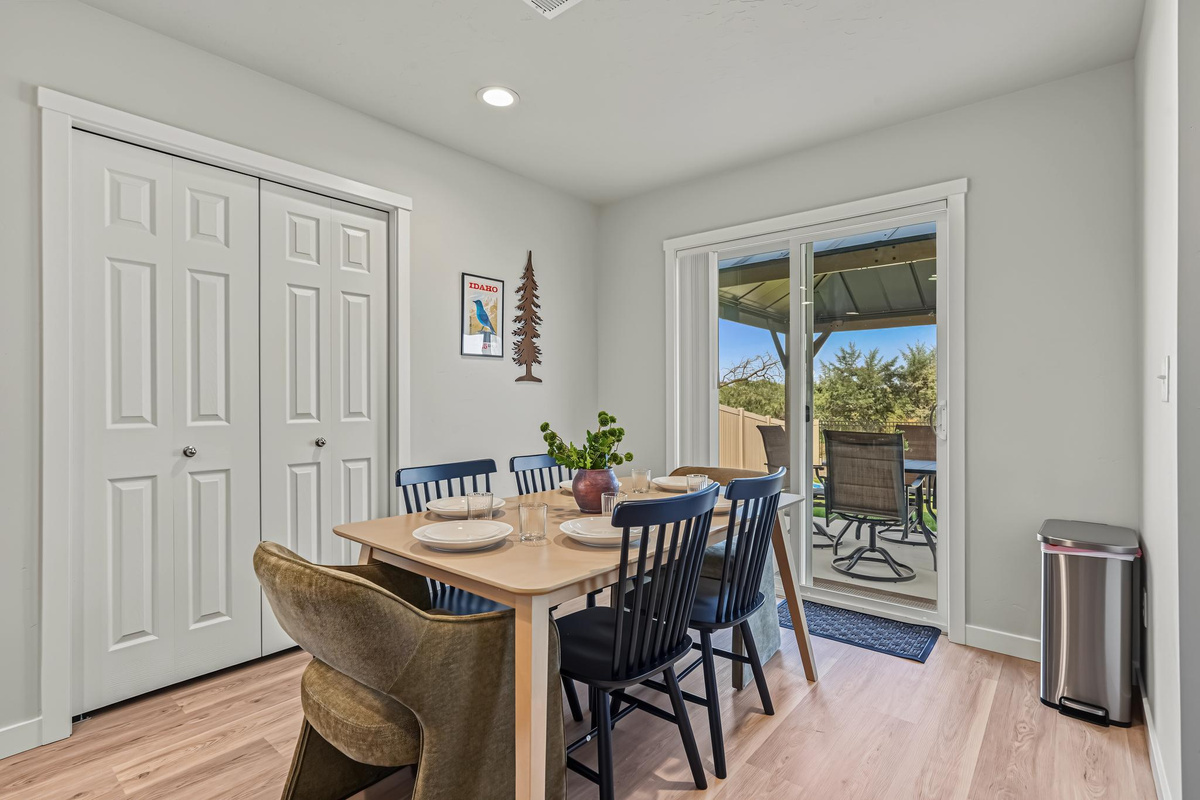 Dinner area that leads outside to the fenced backyard.