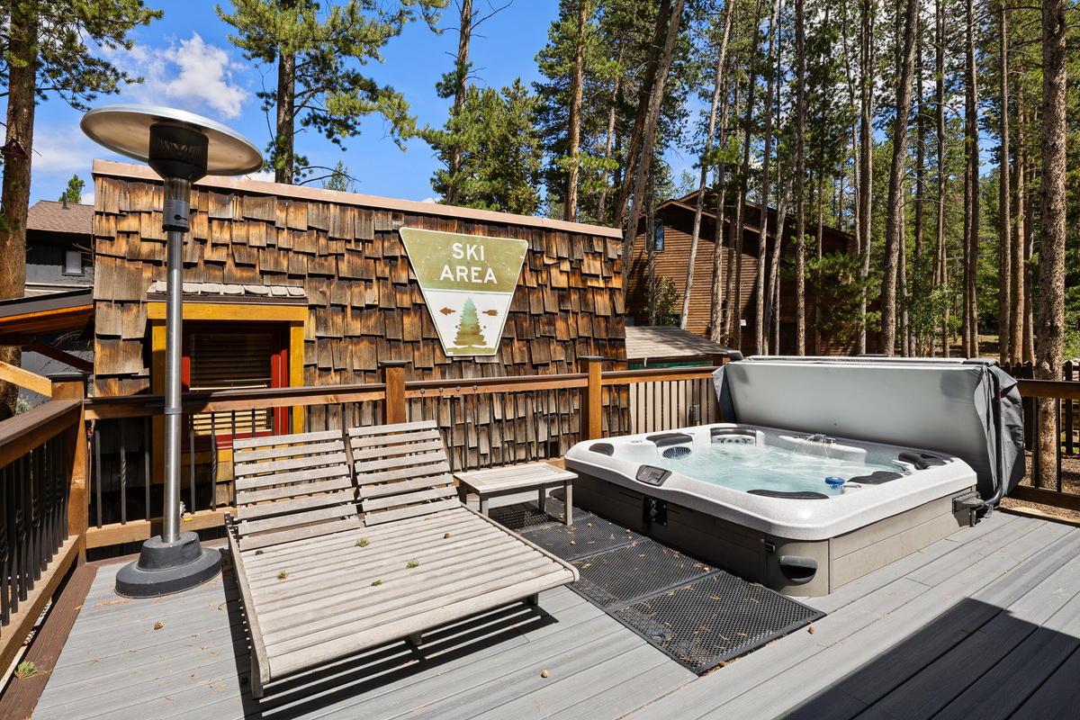 Rear deck with private hot tub, lounge seating and outdoor heater