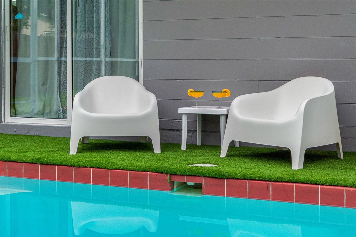 With padded loungers, a mounted outdoor TV, and thoughtful design, this backyard delivers a resort-style experience in full privacy.