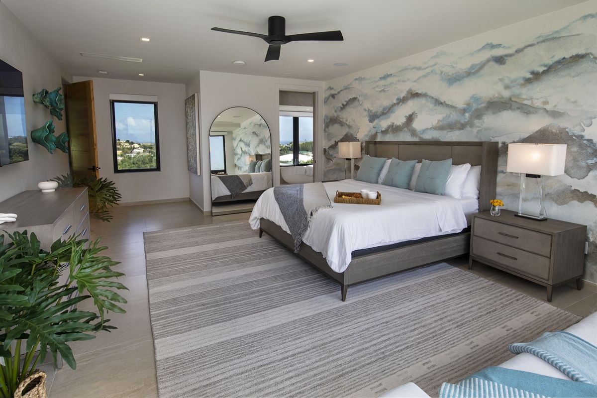 This primary bedroom has surrounding views of both the front and back of property