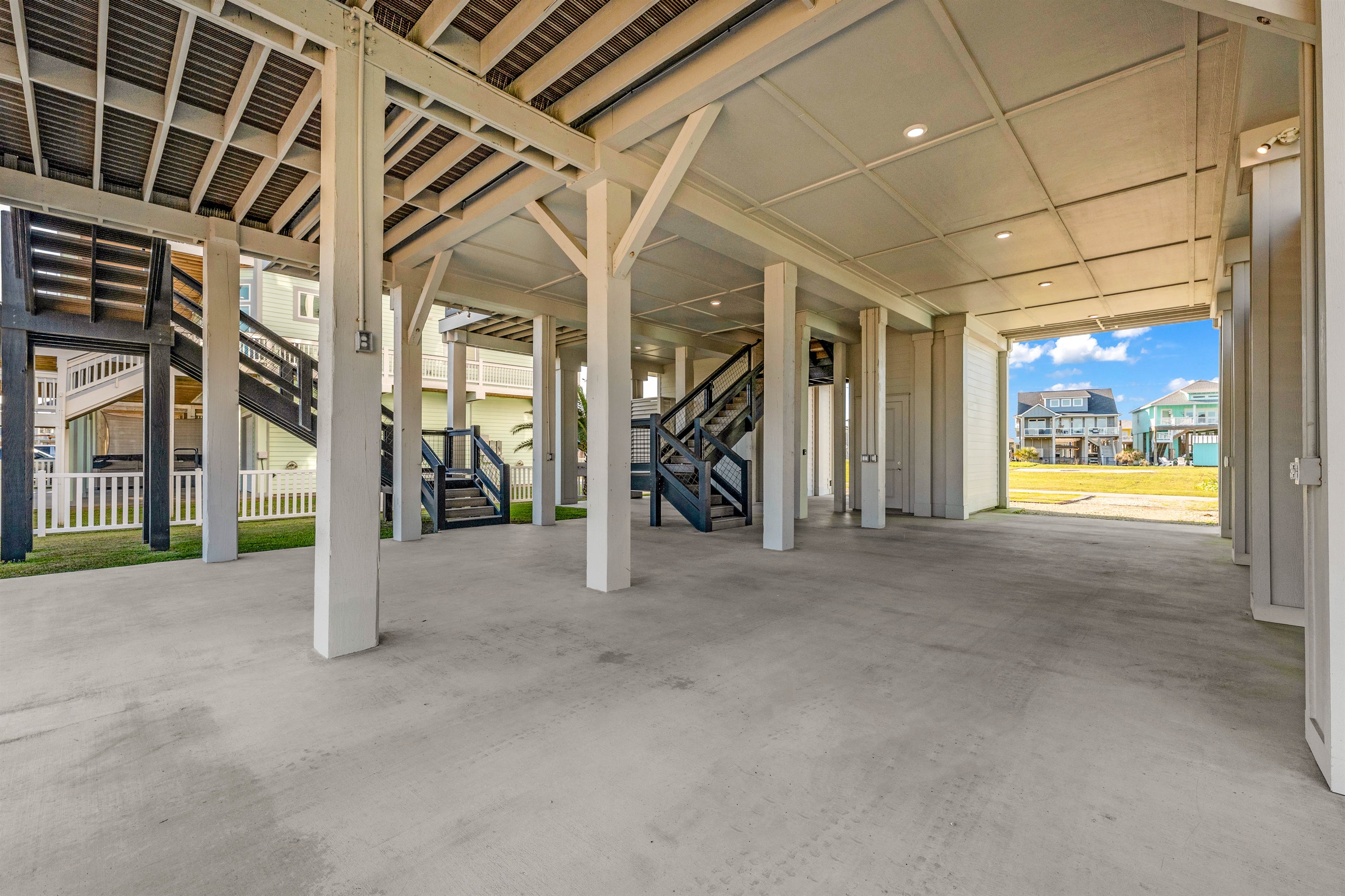 Costa Cristal Outdoor Space: The home features a spacious, well-designed garage, seamlessly integrated into the architecture, offering ample room for vehicles and easy access while maintaining the property’s sleek, luxurious look.