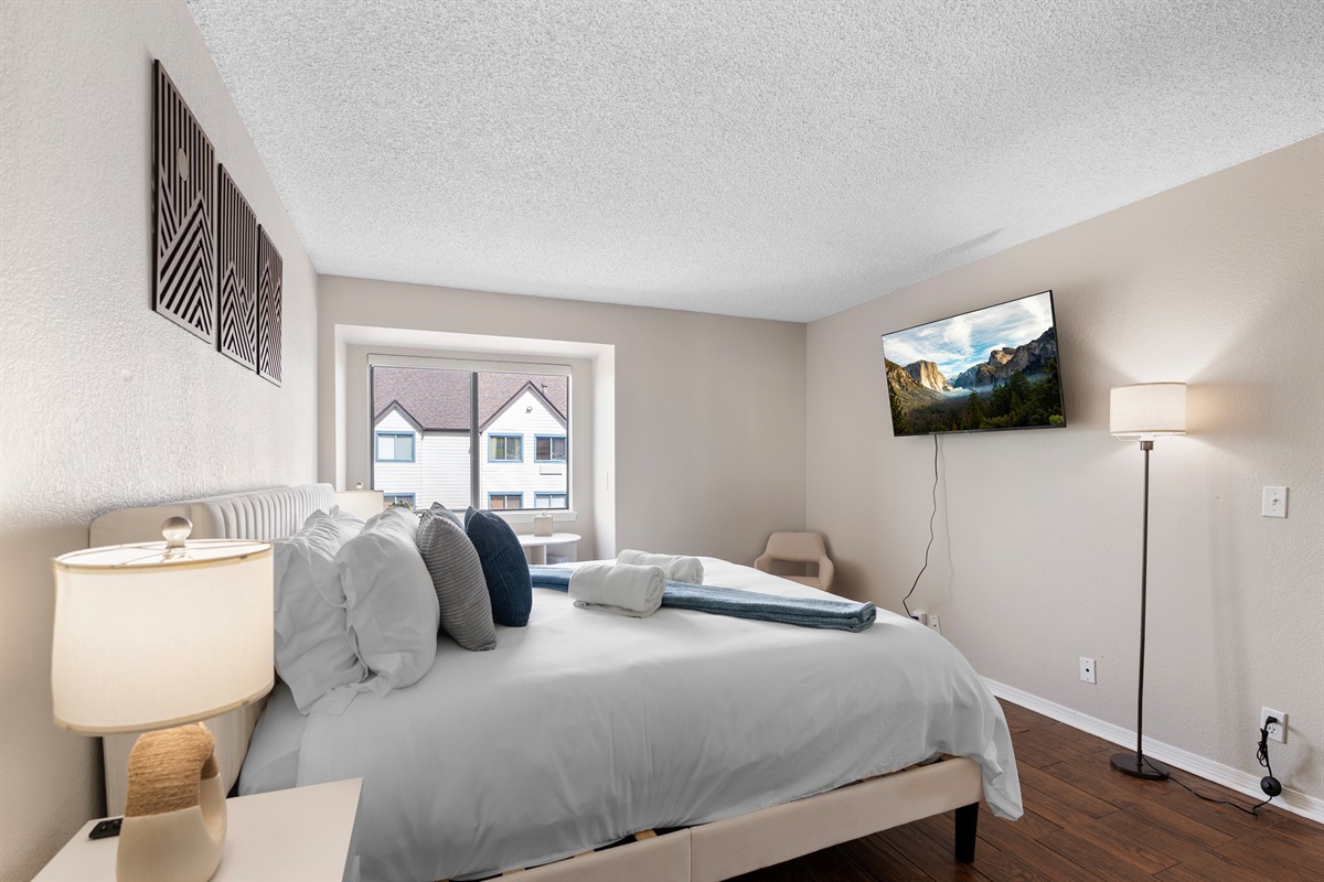Primary bedroom with en suite oversized full bathroom, walk in closet, and office area.