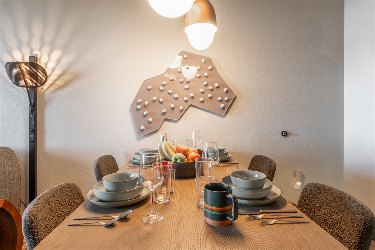 Bold, playful wall art brings character to the dining area, turning everyday meals into something a little more memorable.