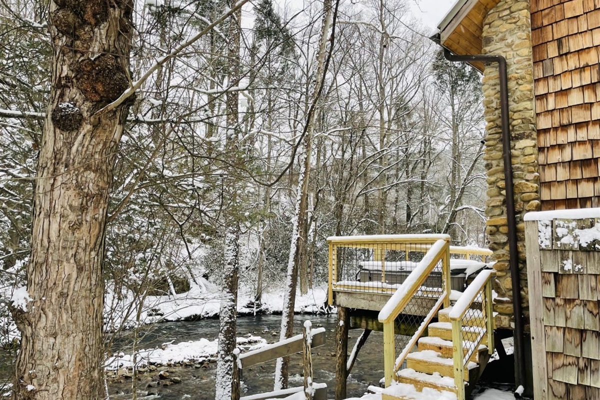 A peek of the hot tub and creek in the snow