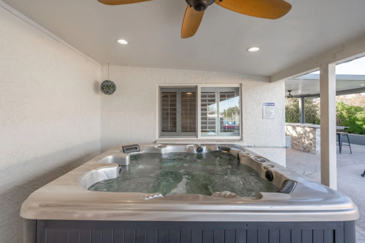 Tucked under a covered patio, this hot tub stays comfortable rain or shine, with ceiling fans keeping the air moving on warm days.
