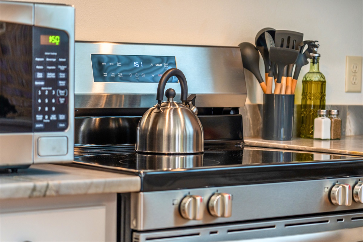 The stove and microwave area is fully equipped with all the tools you need for preparing your favorite meals.