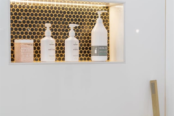 Our modern bathroom features top-notch shampoo and conditioner for your hair care needs! Feel refreshed and ready for the day ahead.