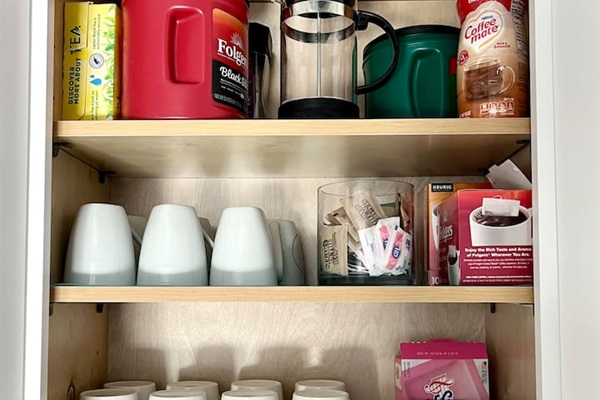 Stocked kitchen with coffee, decaf coffee, tea, cream and sugar.