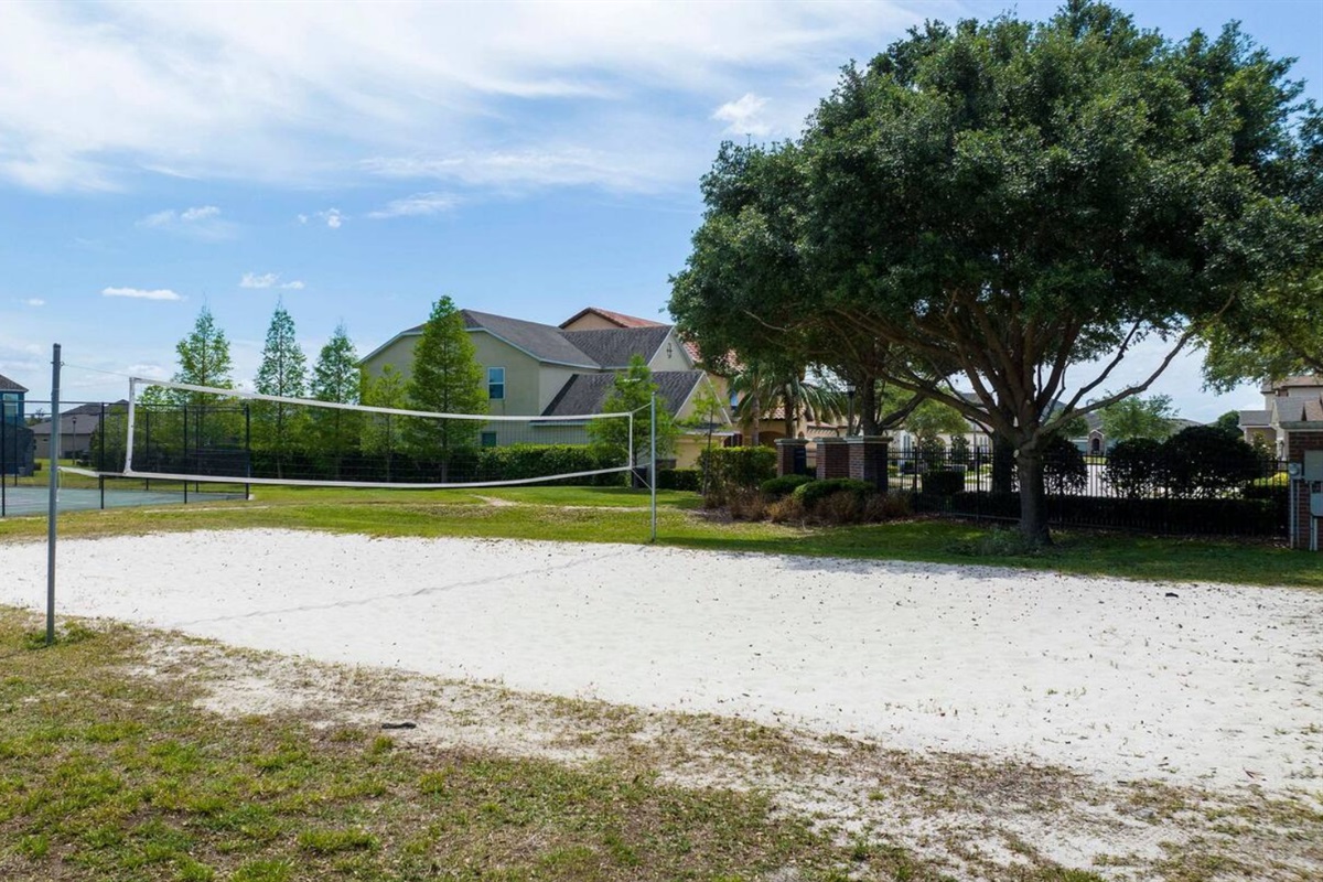 Sand volleyball court and green spaces for outdoor fun.
