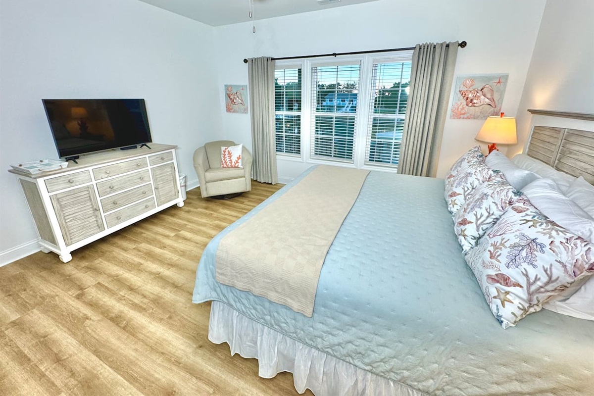 The primary bedroom has a King bed, smart TV, blackout curtains, and water view.