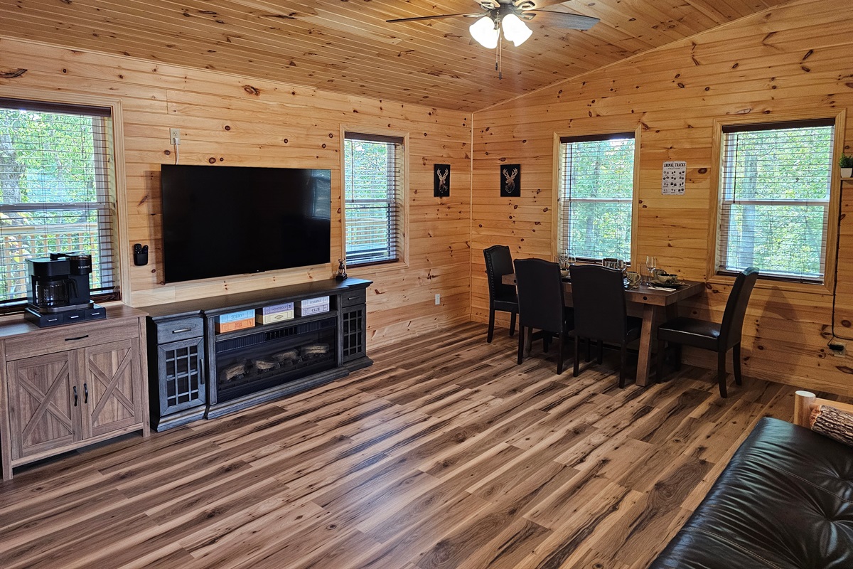 Gather for meals, game nights, or movies in this warm and woodsy open space.
