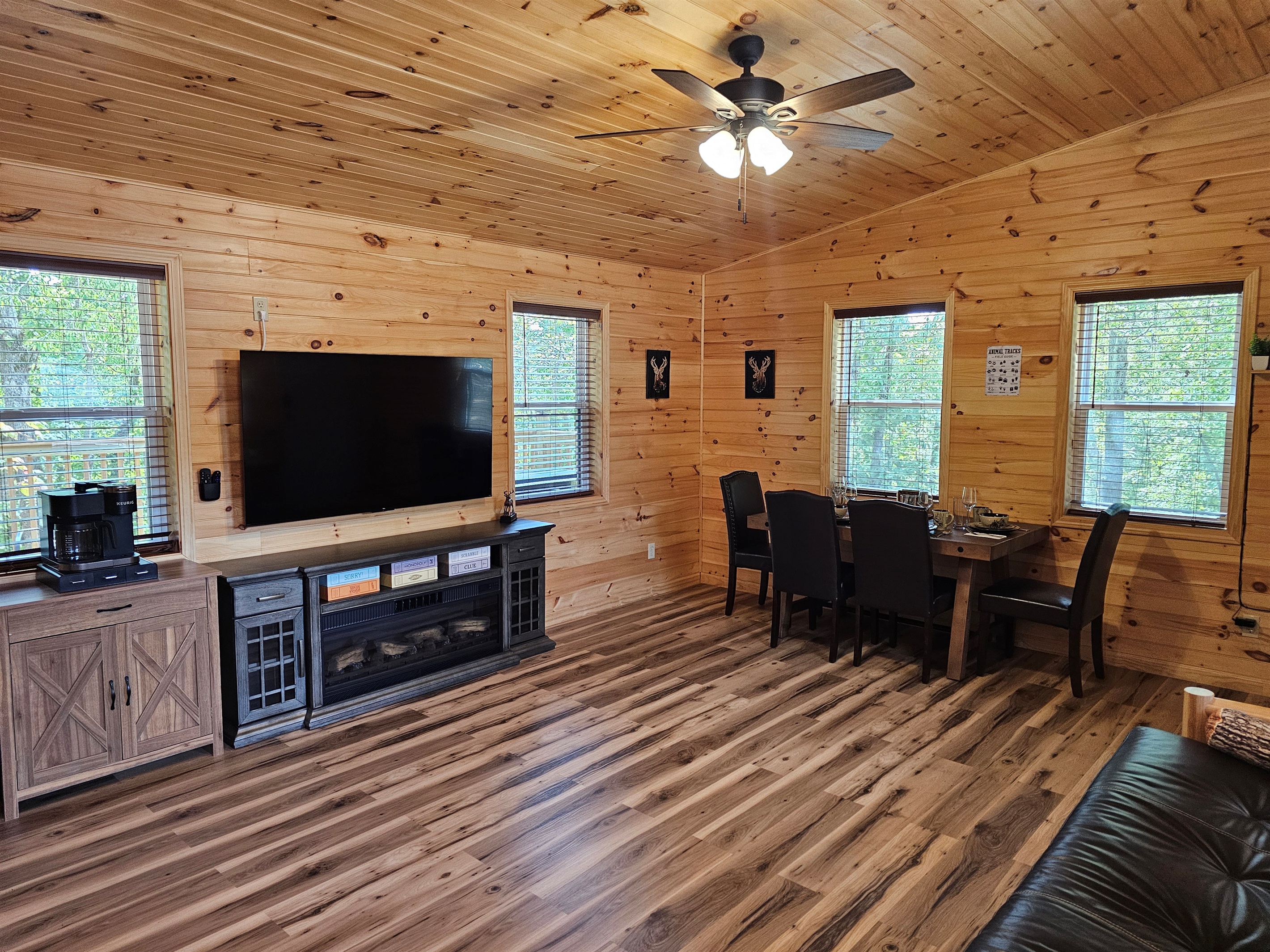 Gather for meals, game nights, or movies in this warm and woodsy open space.