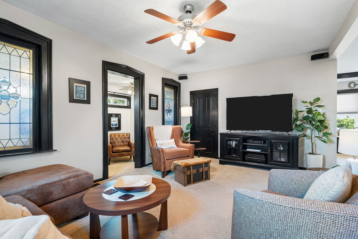 Spacious family room with ample seating and a 65-inch smart TV.