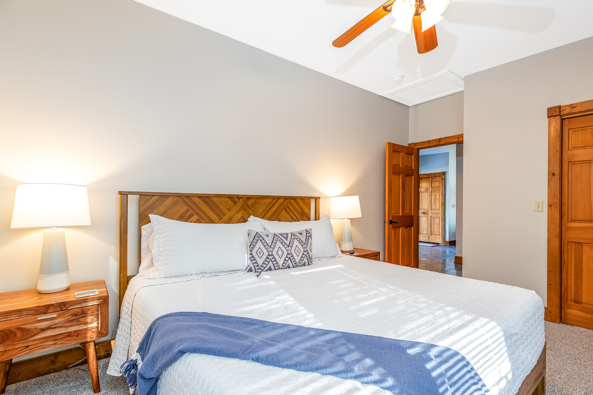 Bedroom 2 featuring a King bed and a Roku Smart TV, and a bathroom directly adjacent to the bedroom; one of two bedrooms located on the main floor.