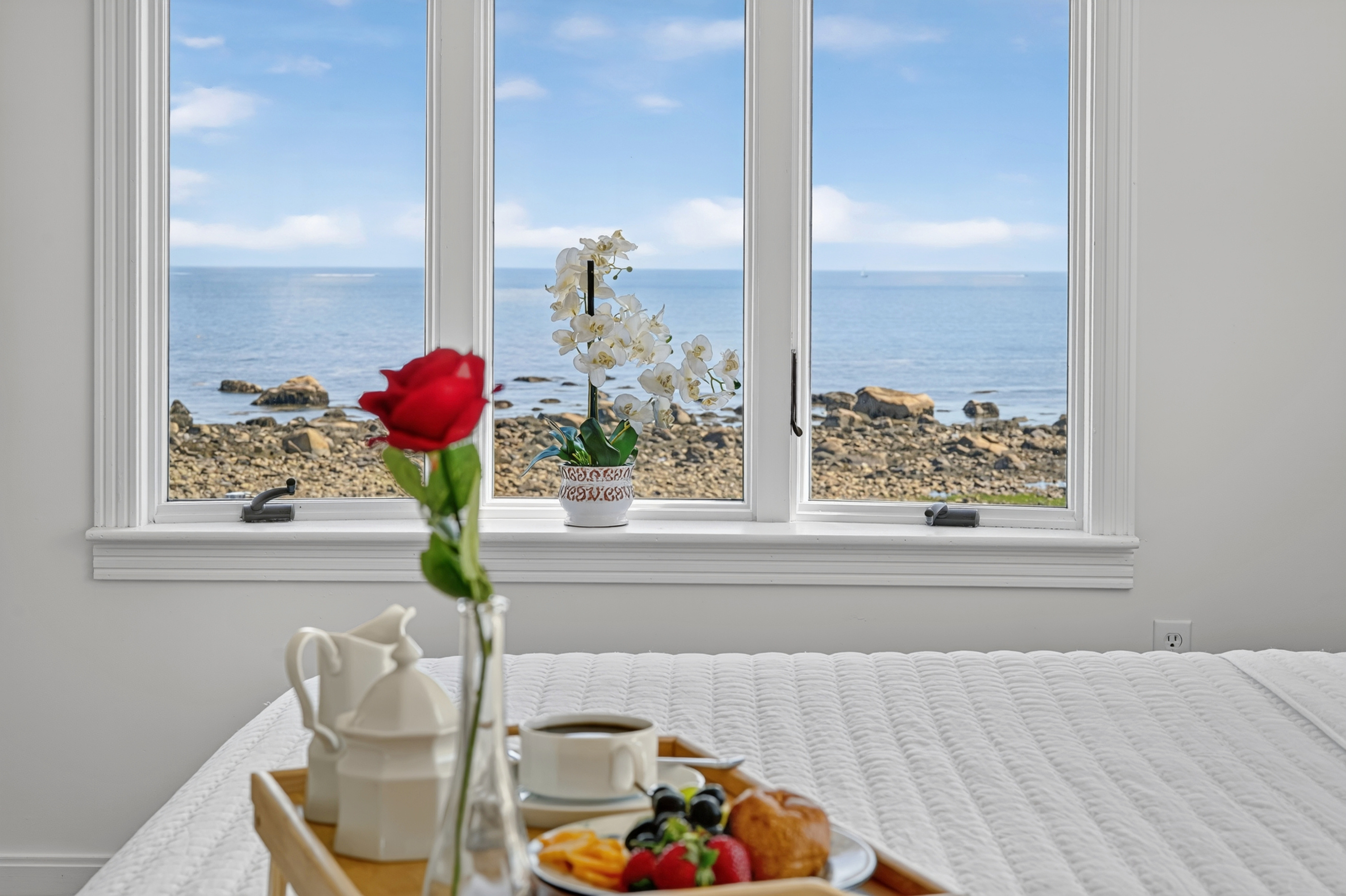 Wake up to breathtaking ocean views from the comfort of your bedroom with floor-to-ceiling coastal scenery.