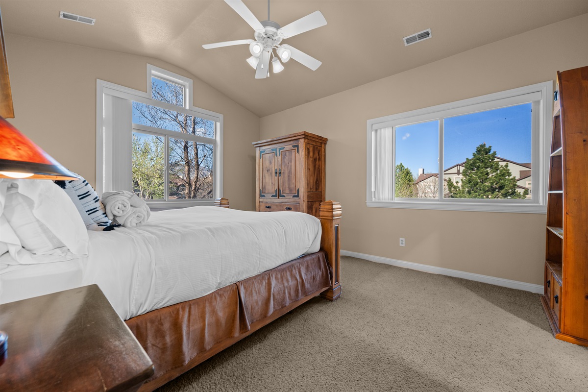 Spacious primary suite with vaulted ceilings, natural light, and peaceful ambiance.