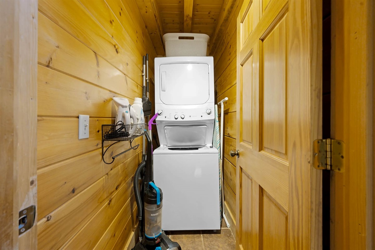 Laundry room includes a laundry basket, an iron, ironing board, steamer, mop, and vacuum. Starter amount of laundry pods included.