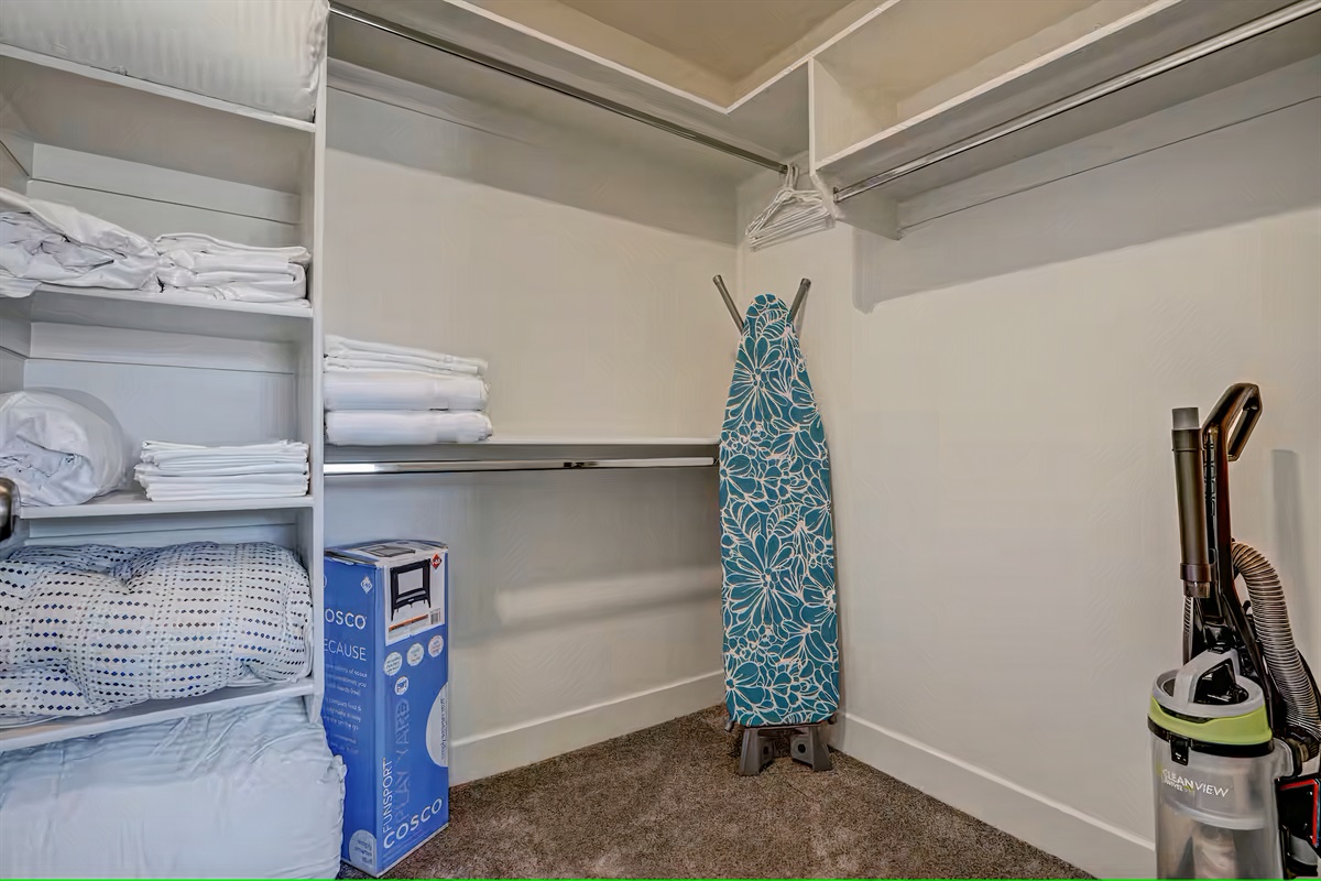 Portable crib, ironing board, Iron, extra linens, and towels.