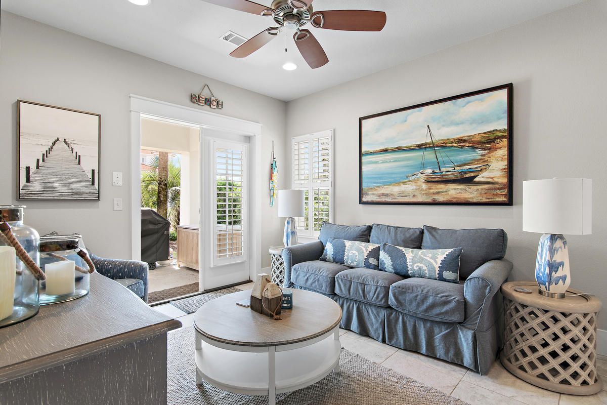 Cozy up in this bright coastal living space, with a comfortable seating area and easy access to the outdoor patio.