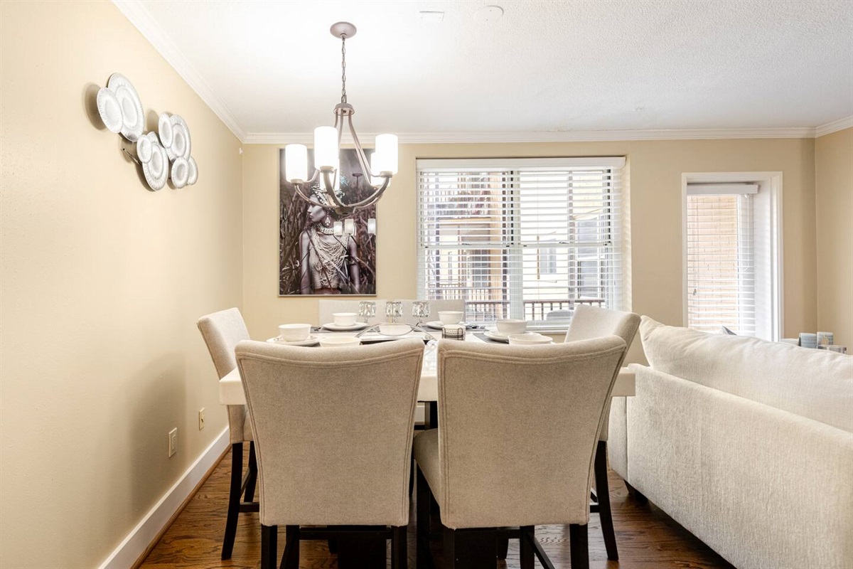 Dining room w/ marble table & stylish lighting for shared meals.