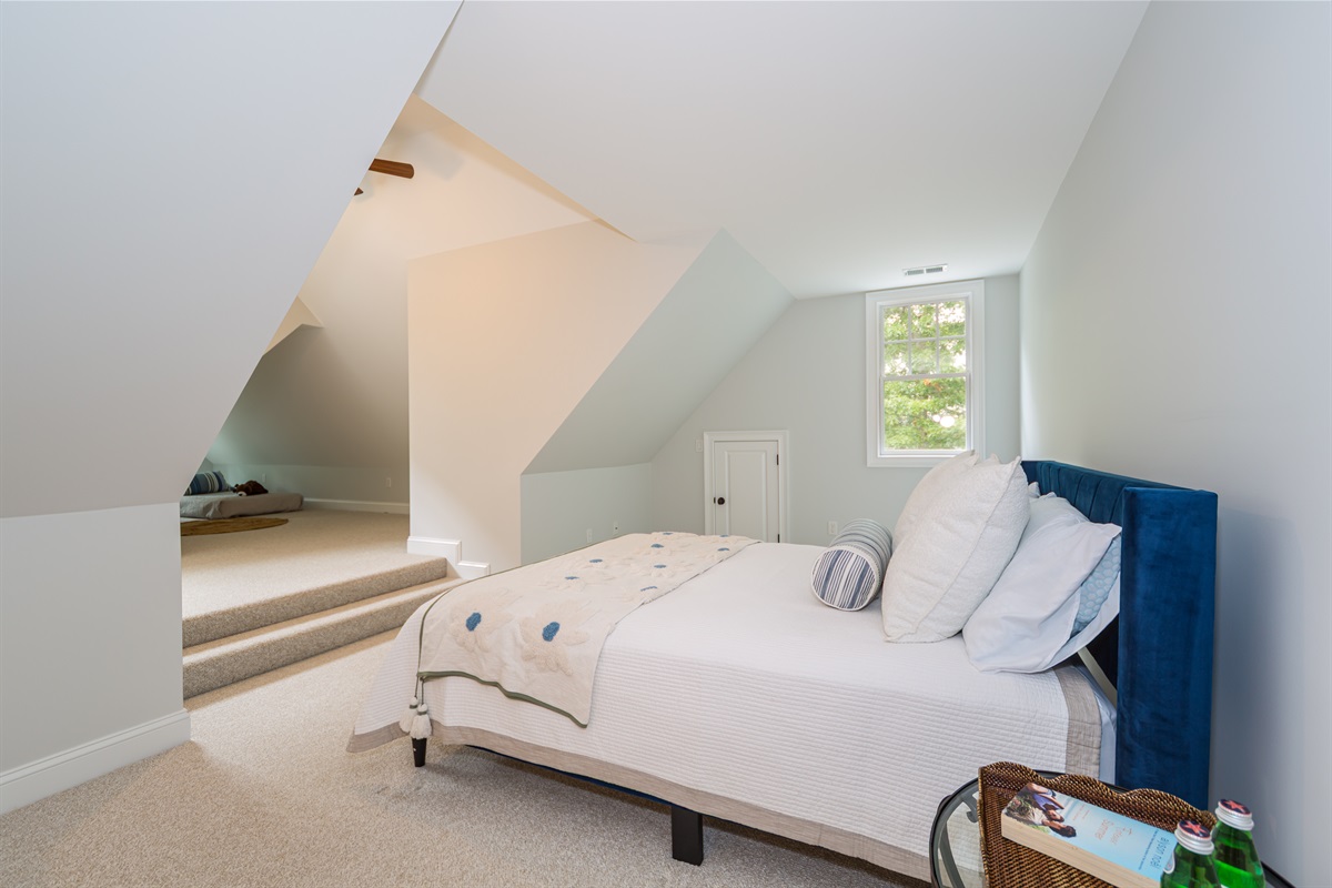 Upstairs Bedroom 4 offers a restful escape with a plush queen bed
