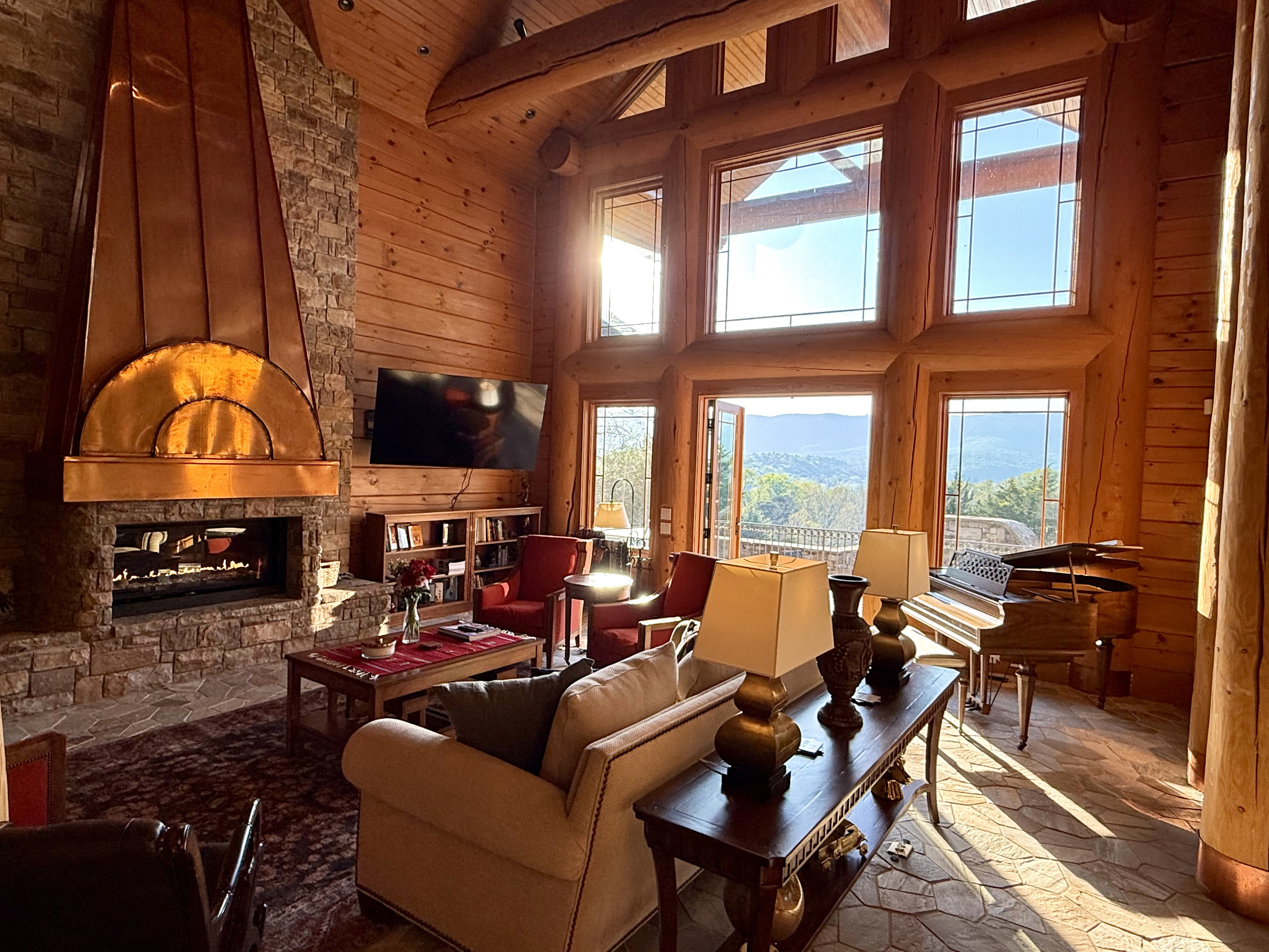 Bright, open living room with a large propane fireplace and stunning views throughout