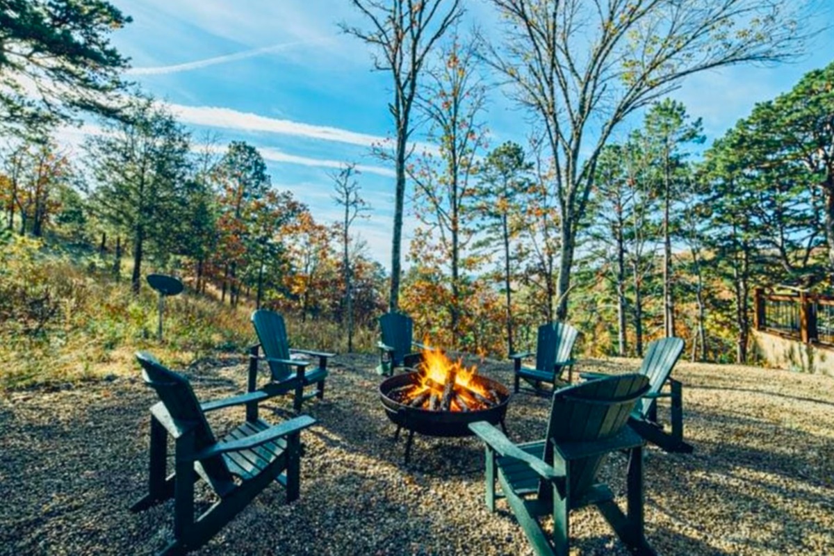 Outdoor fire pit area surrounded by trees, inviting you to gather around for cozy evenings under the stars.