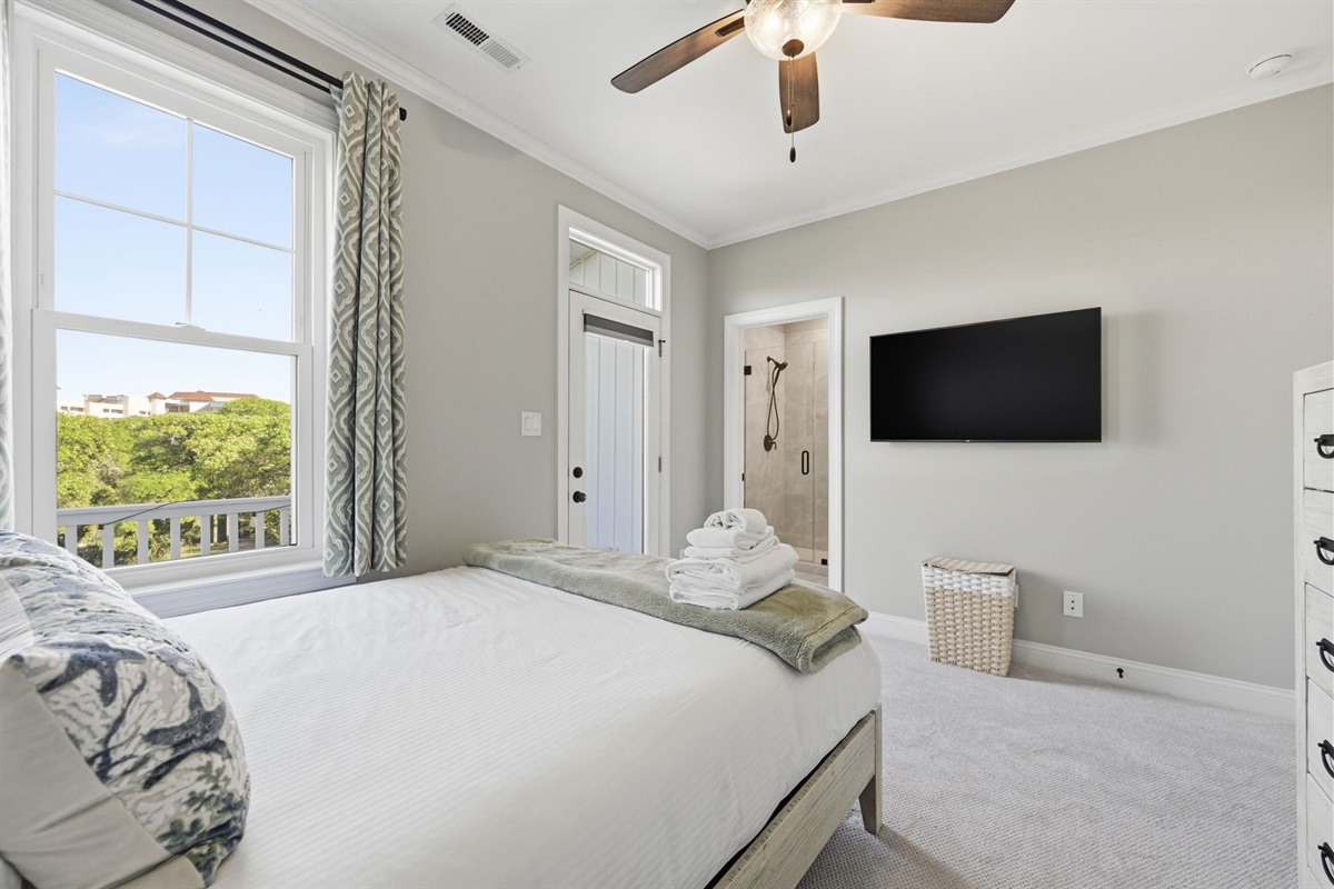 Cozy 2nd-floor retreat featuring plush bedding, natural light, and an ensuite-style bathroom nearby
