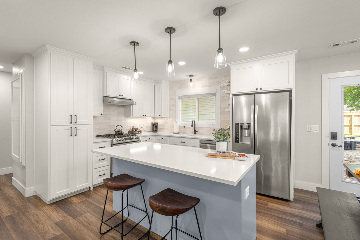 Renovated kitchen with stainless appliance, gas stove, convection oven, and quartz countertops