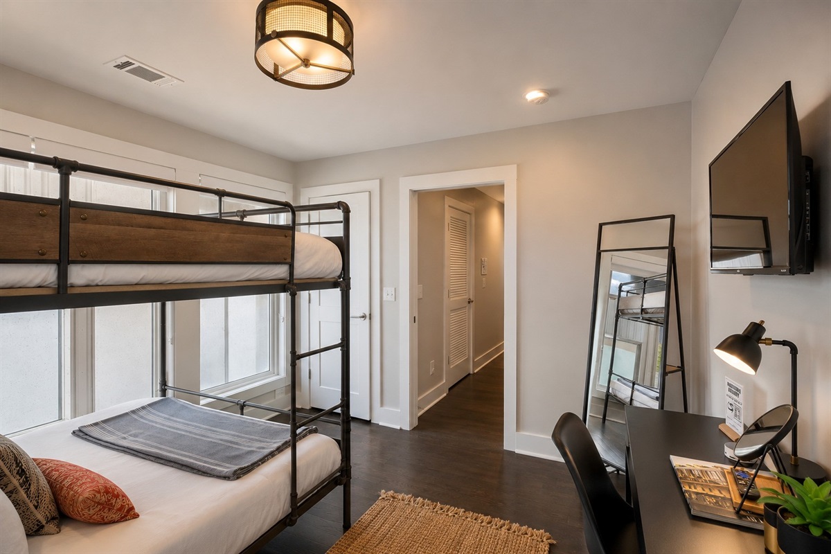 Take the lower bunk and you still get a real bed &mdash; queen-size mattress, layered bedding, and enough space that it doesn't feel like a consolation prize.