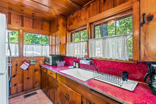 Charming cabin kitchen with classic details, natural light, and everything you need to prepare simple, delicious meals.
