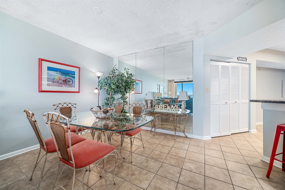 Dine in style with ample space for everyone. This inviting dining area features a charming table for family meals, complemented by additional seating at the convenient breakfast bar.