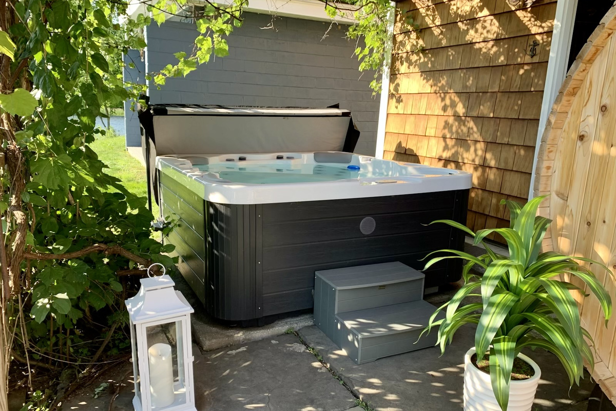 Your private River Spa Patio features a premium hot tub, cedar barrel sauna, and a secluded space to relax after a day on the water.