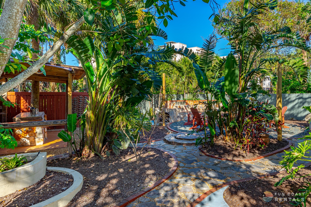 Fully fenced private string lit zen Backyard with wood fire pit!
